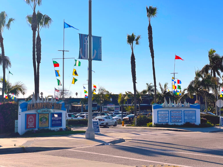 a unique picture of alamitos bay landing in long beach, california. long beach waterbikes is in the center of the entrance to the shopping center.