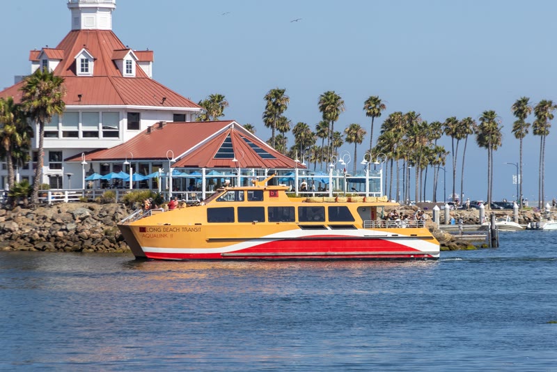 The yellow and red Long Beach Transit AquaLink II water taxi entering Alamitos Bay Marina