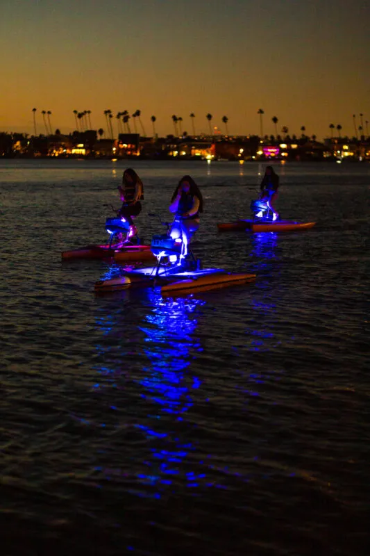 Riders on hydrobikes under the Naples bridge