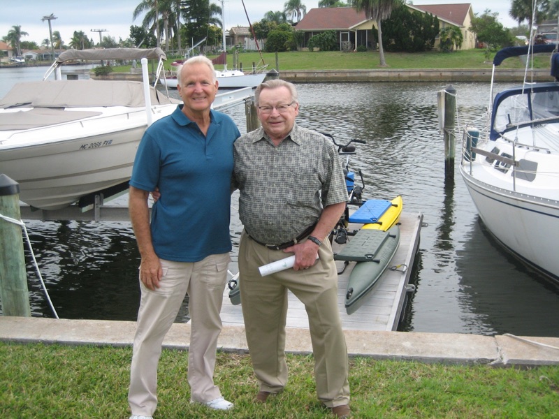 Ray Buresch, inventor of the Hydrobike, standing on a Florida dock beside Hydrobikes dealer Bob Thayer, with a Hydrobike behind them