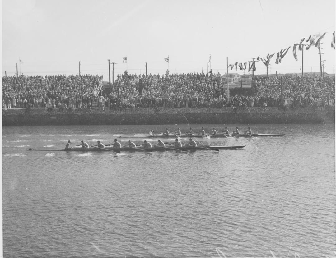 Rowing crews racing at Marine Stadium, Long Beach, 1932 Olympics, with spectators in the stands