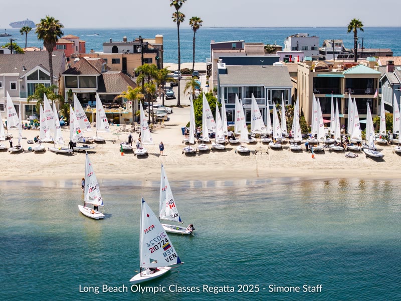 Rows of small sailboats on the beach and dinghies sailing off the Alamitos Bay Peninsula
